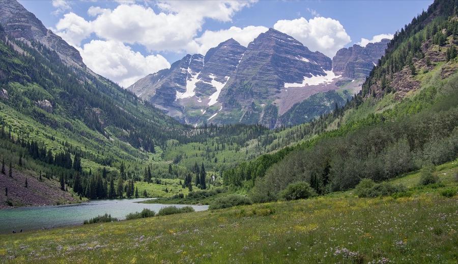 Maroon Lake and a wildflower meadow below the Maroon Bells in summer.