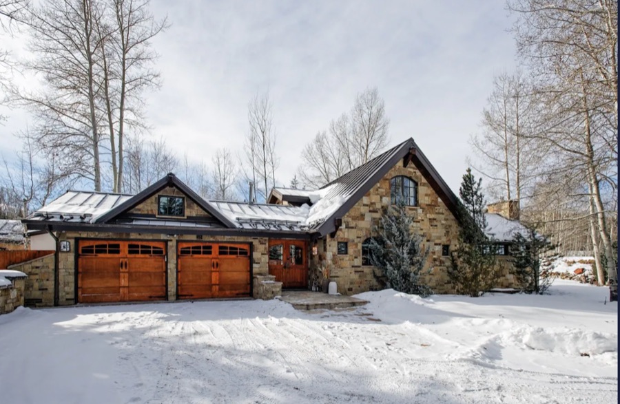 Driveway and timber garage doors in winter.